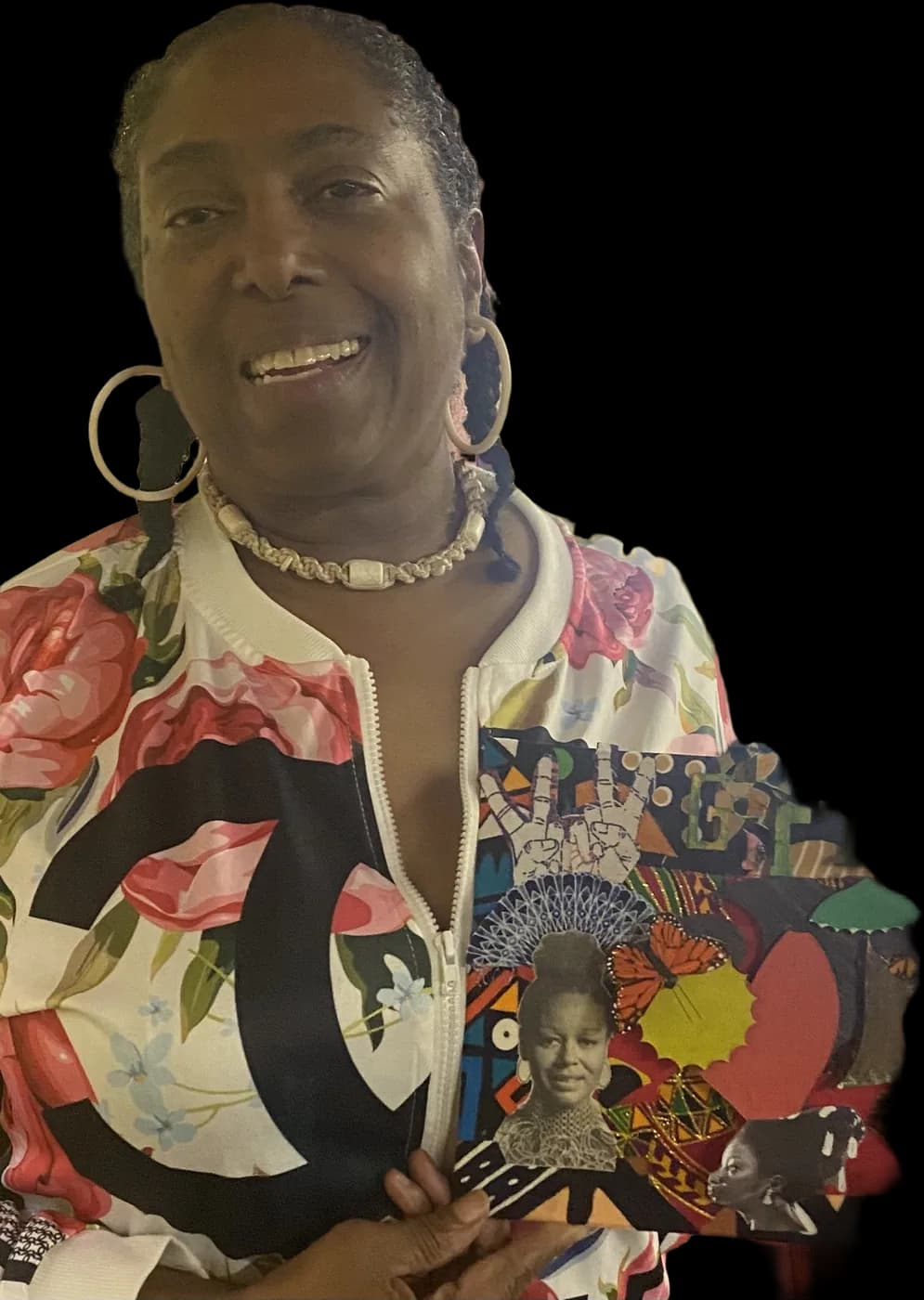 A guest at an Idlewild make & take holding the wide collage panel she finished, honoring Black women in history.